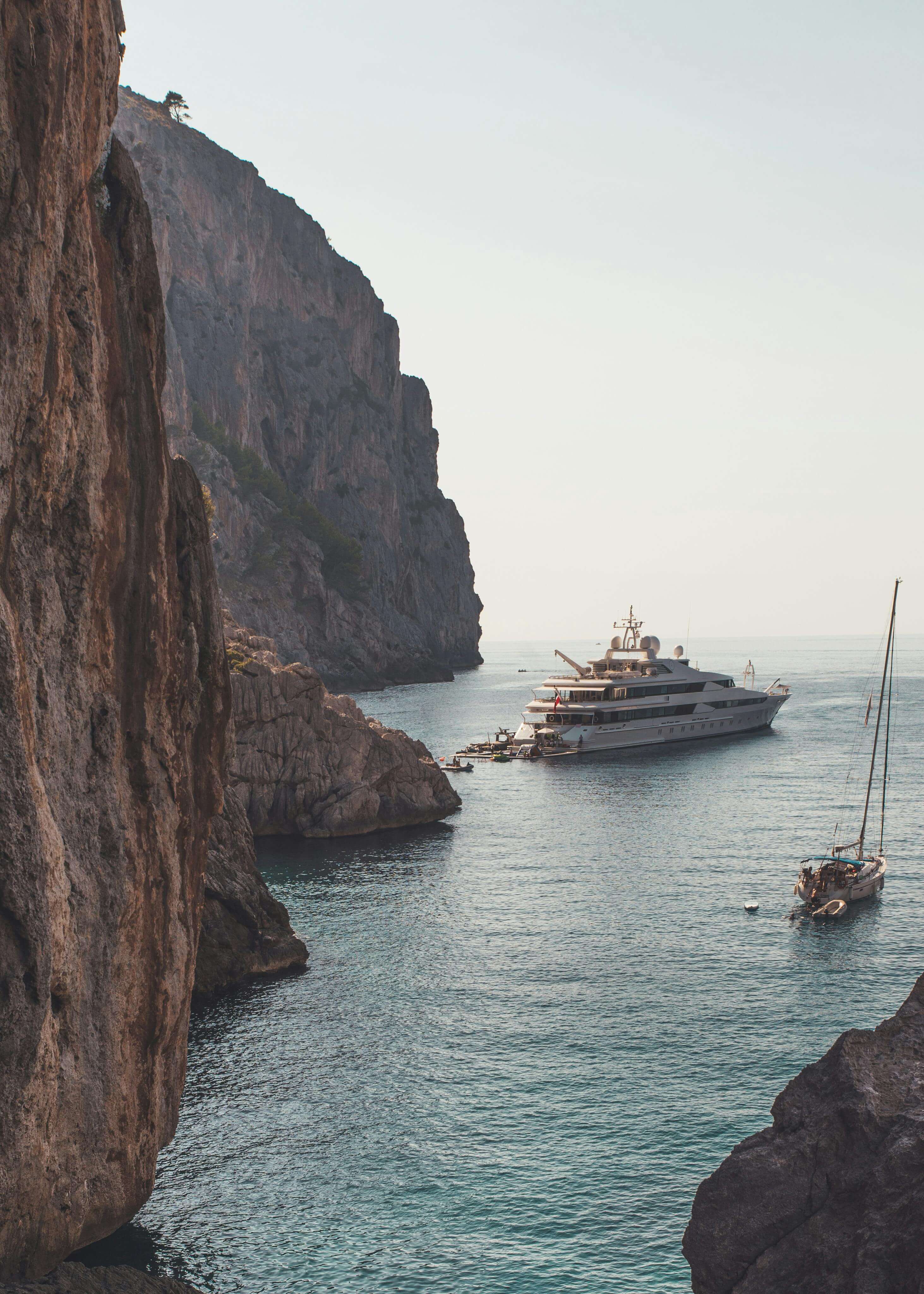 Yacht anchored in a dramatic cliff cove